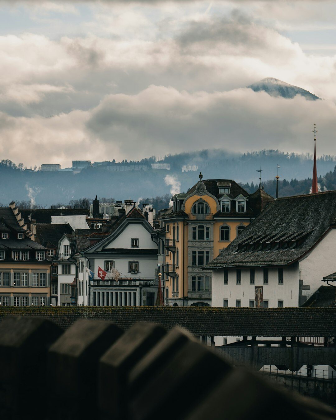 Industrial factory chimneys releasing smoke near a Swiss town