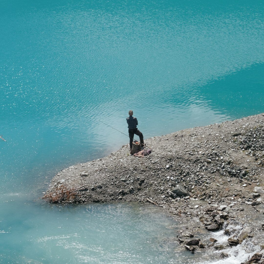 Researcher collecting a water sample from a Swiss lake